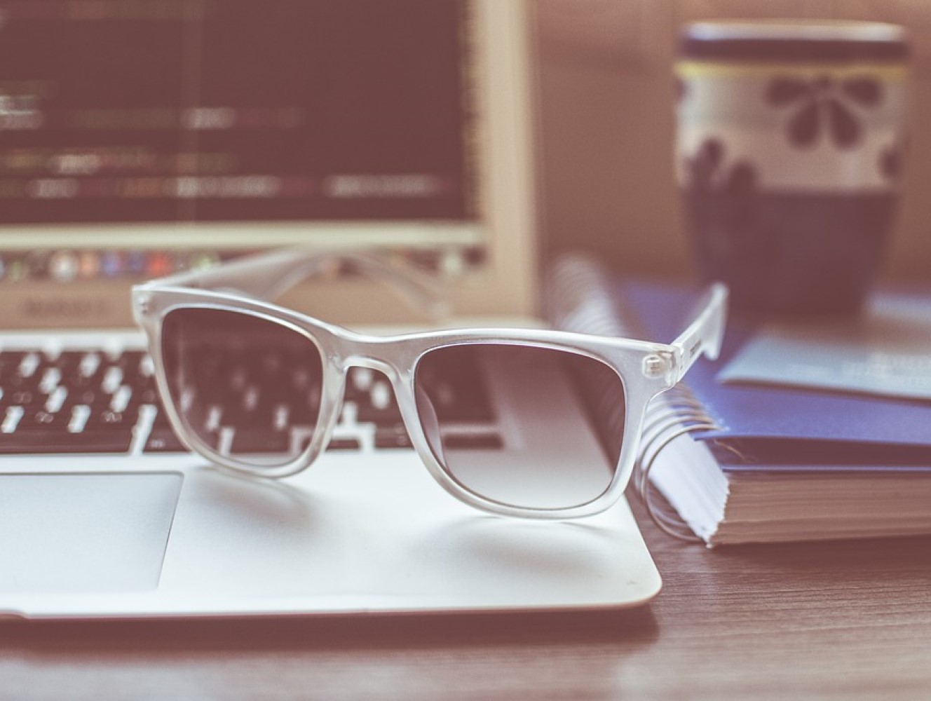 Lunettes de soleil sur l'ordinateur d'une développeuse web en télétravail full remote